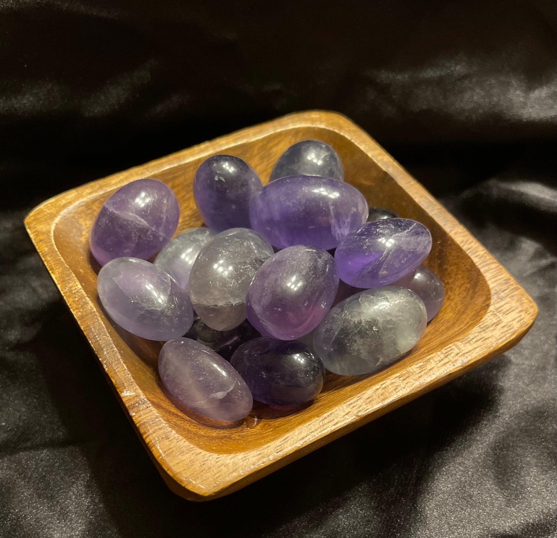 Rainbow Fluorite tumbled stone, held in hand for scale