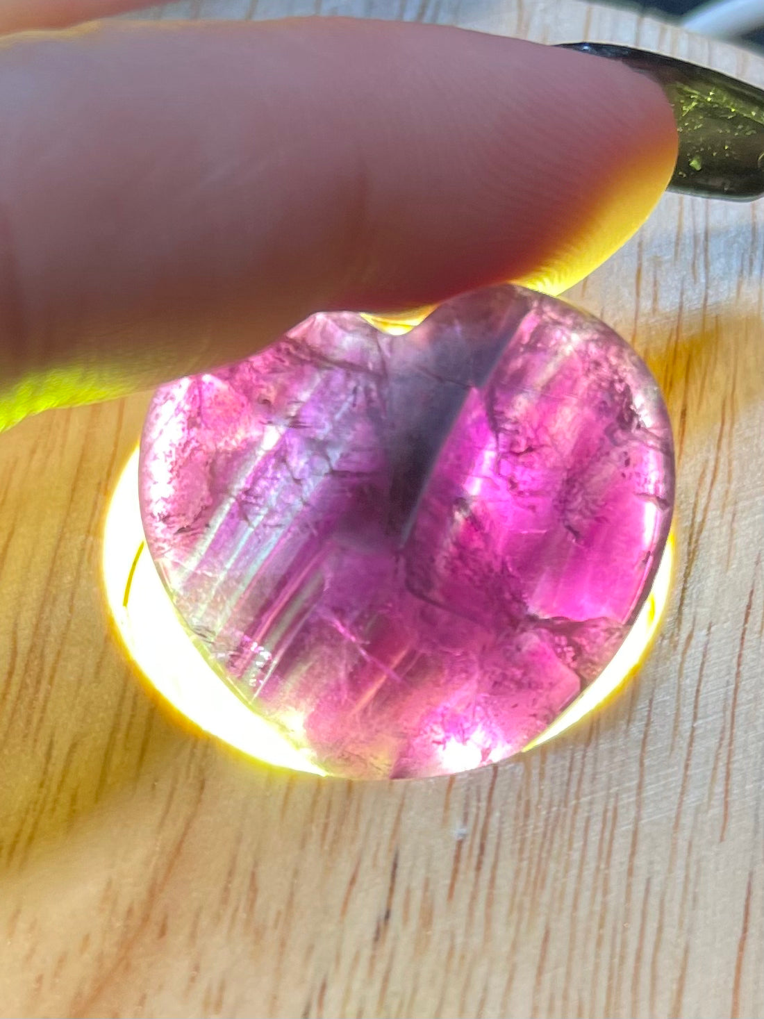 Purple/Rainbow Fluorite crystal heart, shown against a dark backdrop