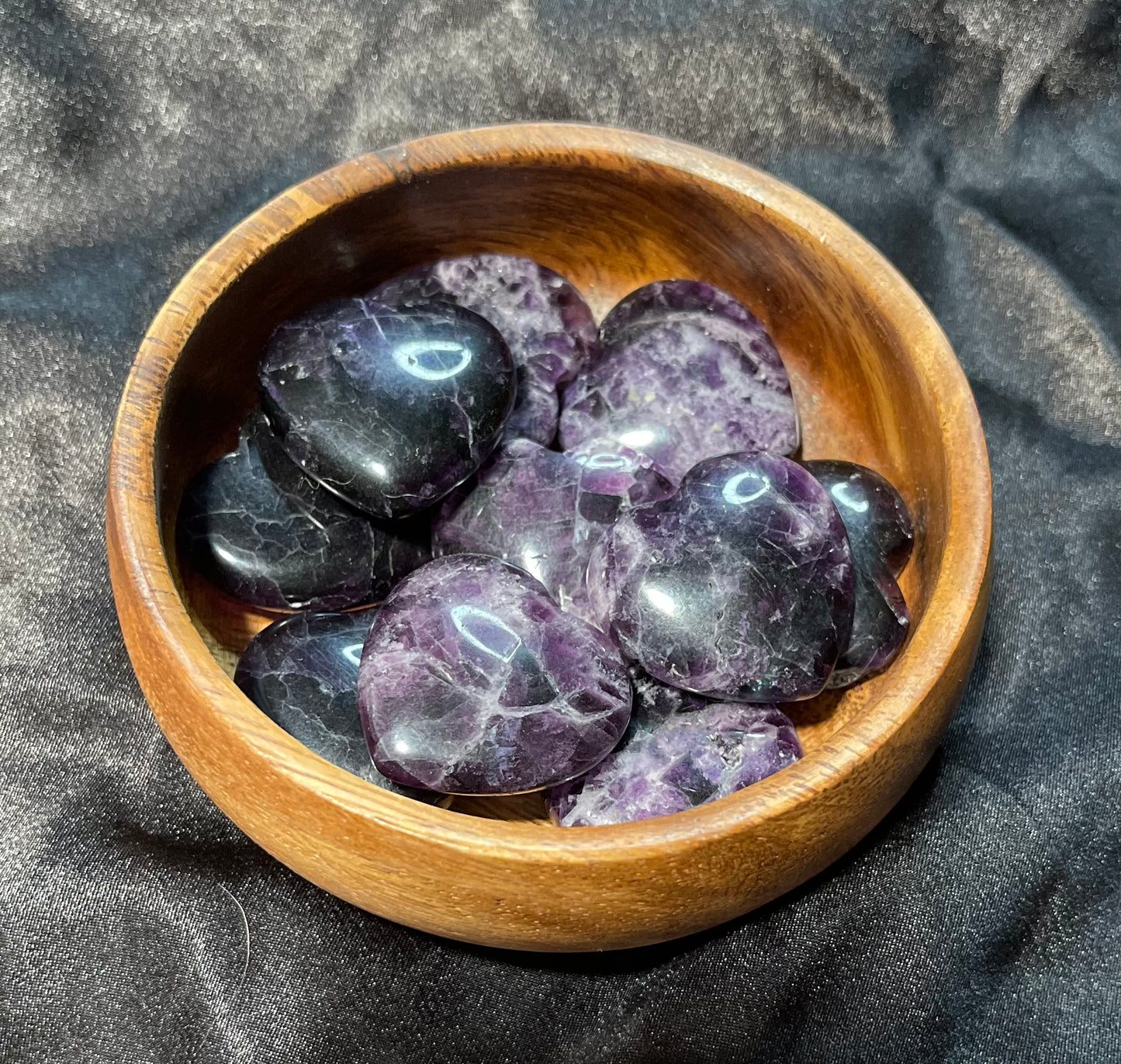 Purple/Rainbow Fluorite crystal heart, held in hand for scale