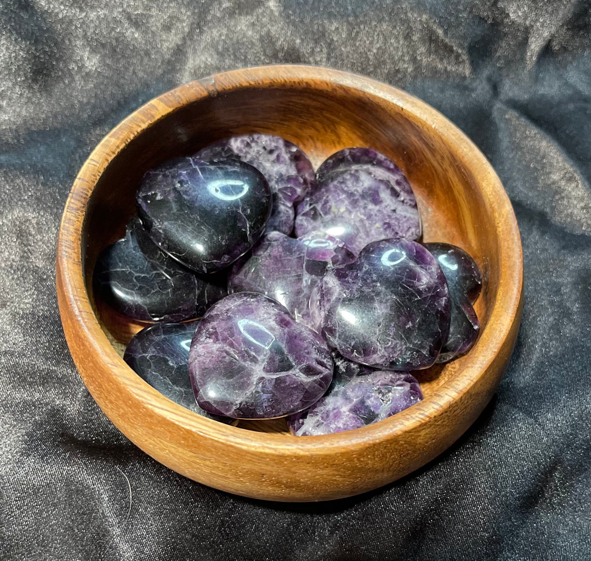 Purple/Rainbow Fluorite crystal heart, held in hand for scale