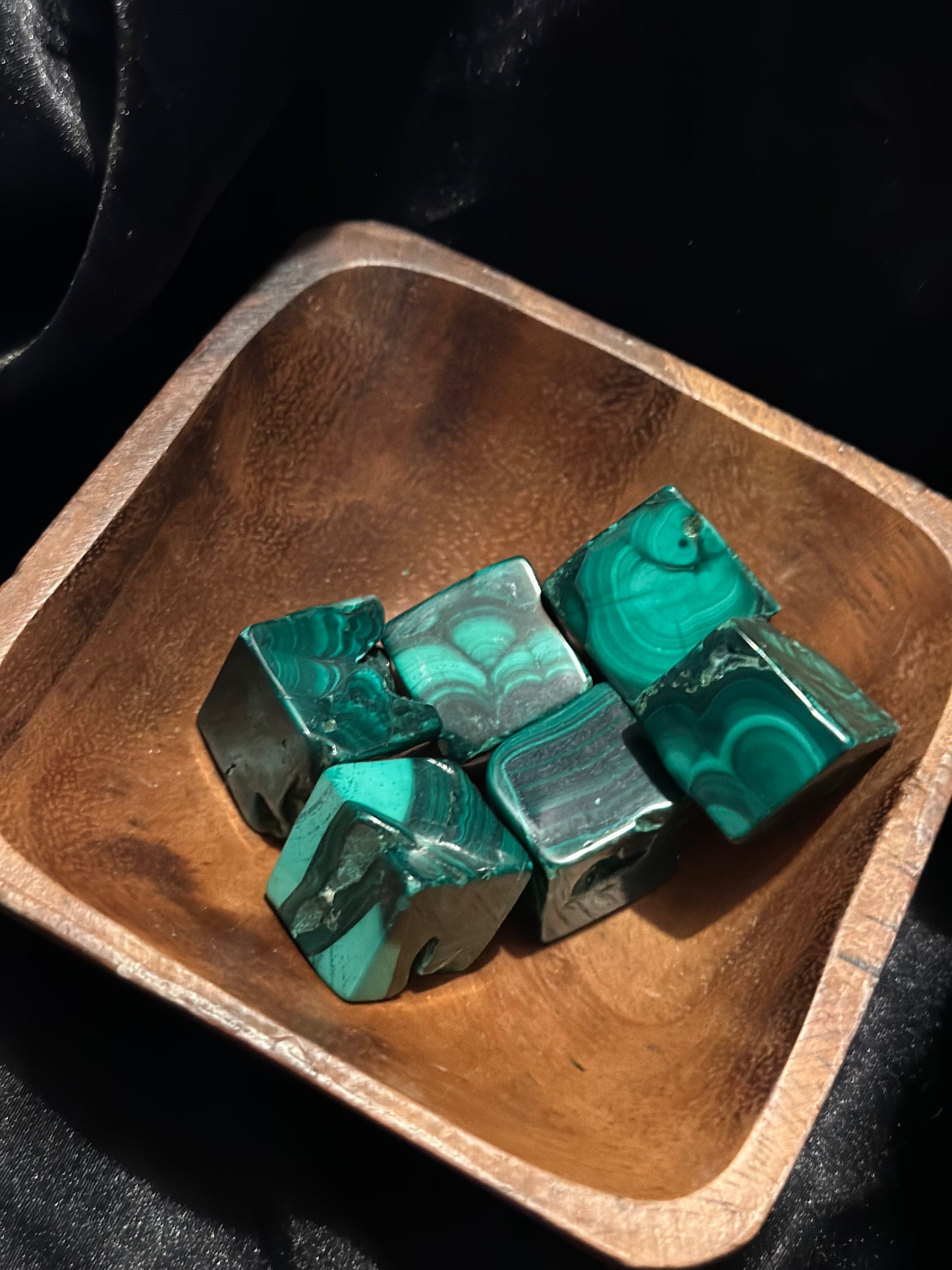 Malachite tumbled stone, turned to catch the light